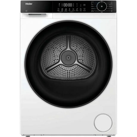 Haier X Series 5 white heat pump washing machine with large black perforated drum, digital display panel, and control dial on top