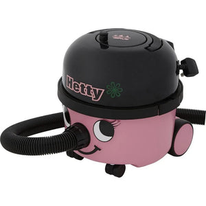 Hetty vacuum cleaner in pink and black with cute face design, compact cylinder shape, black hose attachment, and wheeled base