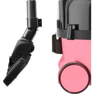 Hetty Vacuum Cleaner in pink with black hose and wheel attachment shown from side angle view