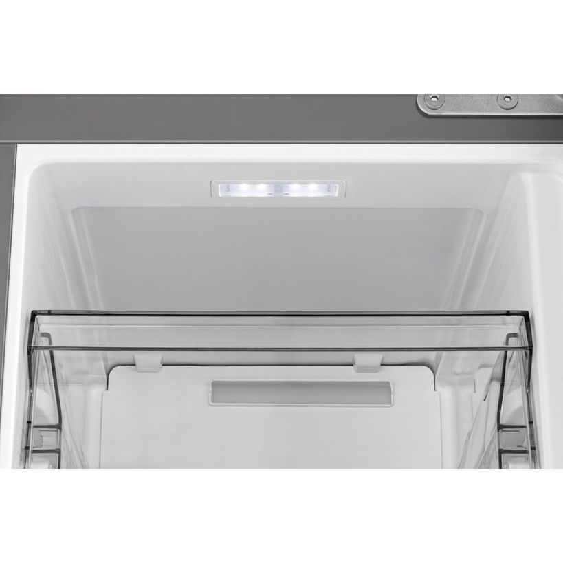 Interior view of empty Hisense PureFlat American Style smart fridge freezer with stainless steel finish showing white compartment, LED lighting, and transparent drawer with black frame