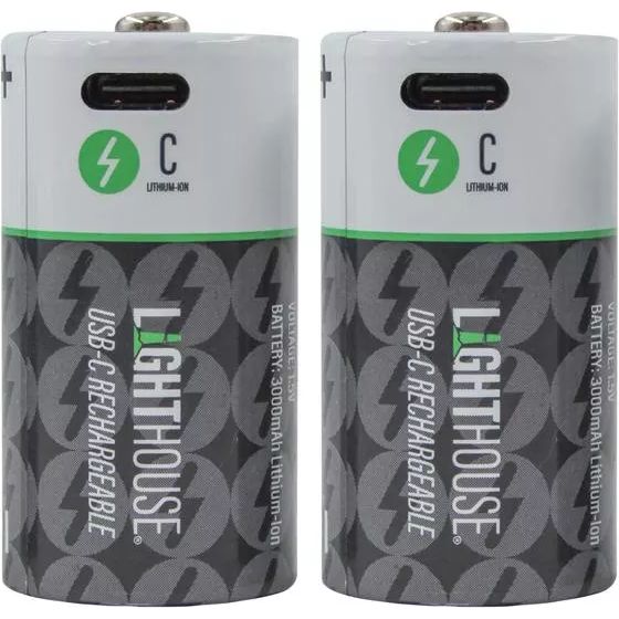 Two Lighthouse USB-C rechargeable C batteries with lithium-ion technology, featuring white tops with green lightning bolt logos and black lower sections with repeating battery icons, displayed side by side