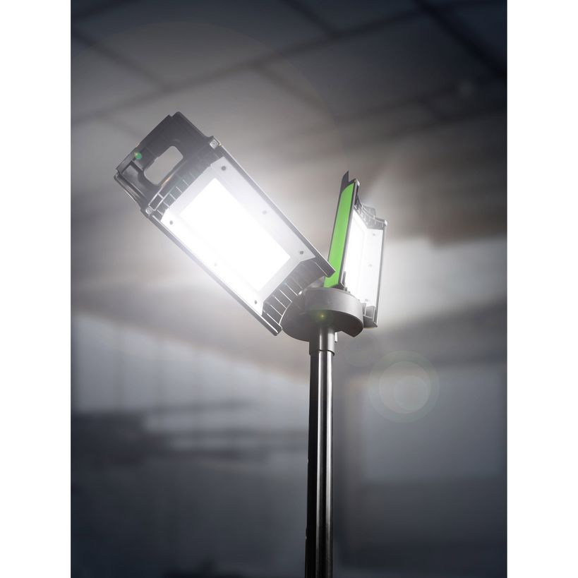 Lighthouse Rechargeable Site Light on Stand showing bright white LED panels with green accents mounted on black metal pole against cloudy sky background