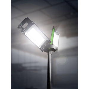 Lighthouse Rechargeable Site Light on Stand showing bright white LED panels with green accents mounted on black metal pole against cloudy sky background