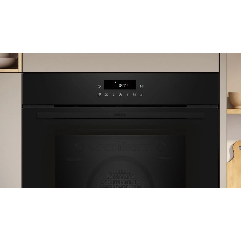 Black built-in single oven with pyrolytic self-cleaning function, digital display showing 180 degrees, touch controls and icons on black control panel, integrated into modern kitchen cabinetry with beige and wood finishes