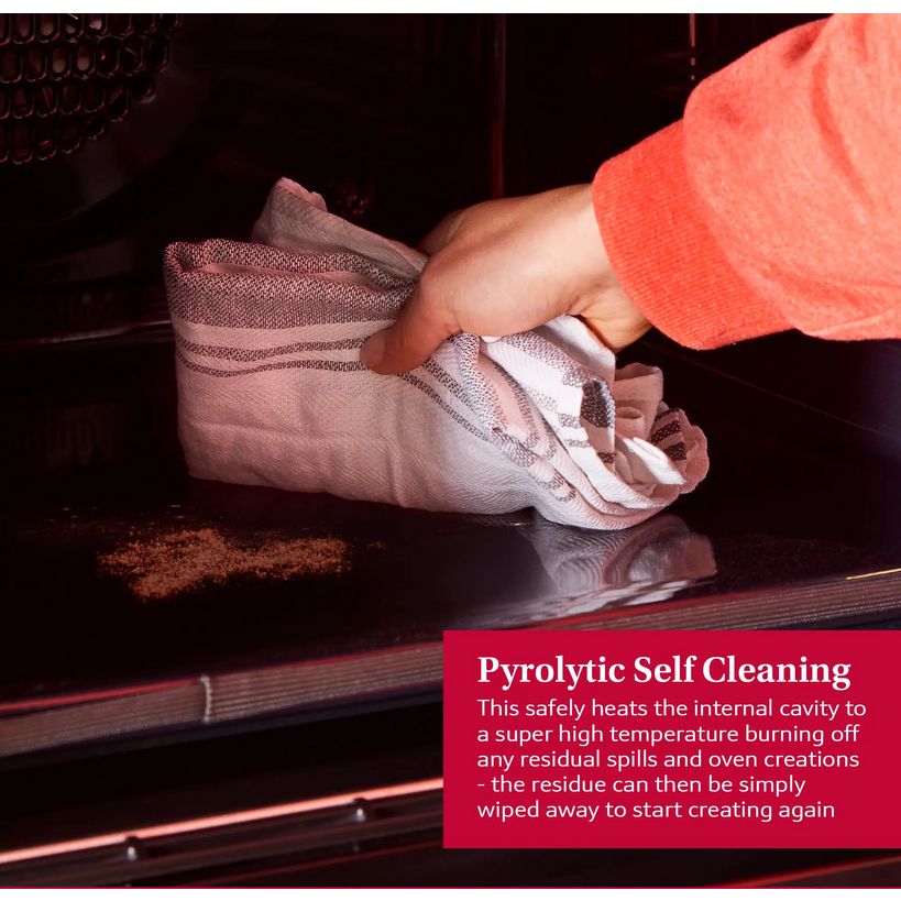 Hand in coral sleeve wiping residue from inside black Neff N30 pyrolytic self-cleaning oven with red informational text box explaining the high-temperature cleaning process