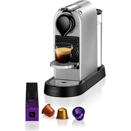 Nespresso Citiz silver pod coffee machine with water tank, drip tray and capsules including purple Nespresso sleeve, copper brown capsule, gold capsule and purple capsule displayed in front