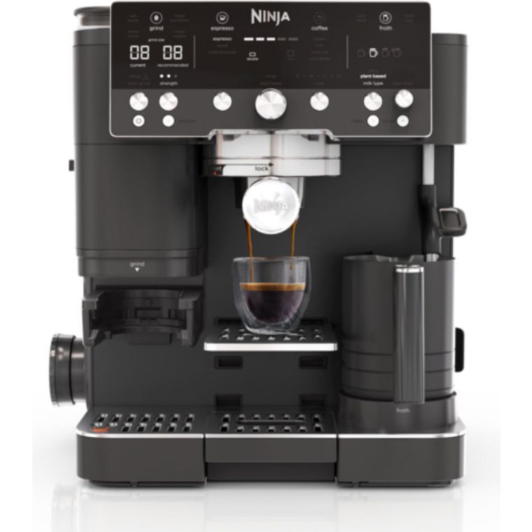 Ninja Luxe Café Premier Series black automatic espresso machine with digital display, brew options, steam wand, and cup dispensing espresso into a glass cup