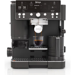 Ninja Luxe Café Premier Series black automatic espresso machine with digital display, brew options, steam wand, and cup dispensing espresso into a glass cup