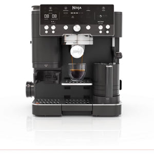 Ninja Luxe Café Premier Series black automatic coffee machine with digital display showing espresso being dispensed into a glass cup, featuring multiple control dials and a built-in milk frother on a white background