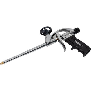 Roughneck expanding foam gun with chrome metal barrel and black plastic trigger handle, featuring a brass nozzle tip and black comfort grip