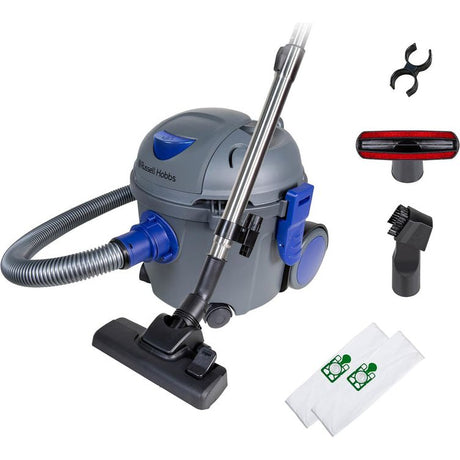 Russell Hobbs Tidy Tub compact vacuum cleaner in grey and blue with accessories including hose, brush head, crevice tool, upholstery nozzle and white dust bags displayed on white background