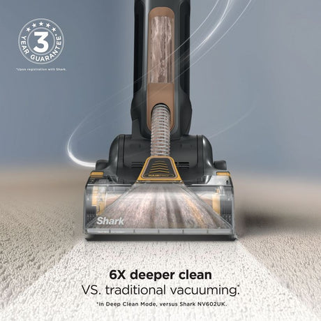 Shark CarpetForce HairPro upright carpet vacuum cleaner in copper and black shown from front view cleaning light grey carpet with text indicating 6x deeper clean versus traditional vacuuming and 3-year guarantee badge