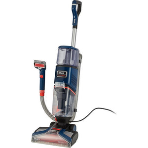 Shark CarpetXpert 3.15 Litre deep carpet cleaner in navy blue and silver with red accents, featuring a tall upright cleaning head, detachable hose with spray nozzle attachment, and wide base platform on white background