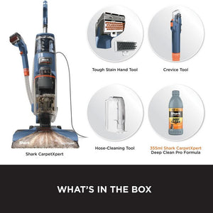 Shark CarpetXpert deep carpet cleaner machine in navy blue and orange with included accessories: tough stain hand tool, crevice tool, hose-cleaning tool, and 355ml Deep Clean Pro Formula bottle shown against white background