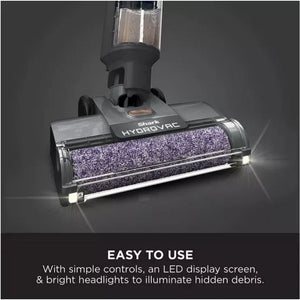 Shark HydroVac cordless vacuum cleaner with purple microfiber cleaning head, water tank attachment, LED headlights and simple controls displayed against dark gray background with easy to use product benefits text
