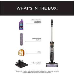 Product contents diagram for Shark HydroVac cordless vacuum showing purple multi-surface concentrate bottle, gray antimicrobial brush roll, orange filter, black charging dock, and black and silver upright vacuum cleaner on white background with labeled components