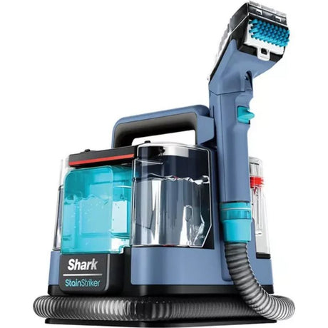 Shark StainStriker portable carpet cleaner in Nordic blue with turquoise accents, featuring a detachable cleaning head, transparent water tank, and coiled hose attachment