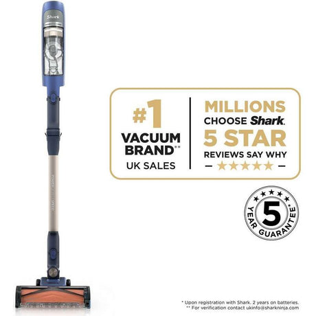 Shark PowerDetect Speed Pet cordless stick vacuum cleaner in ultramarine blue and silver with dust cup, featuring #1 UK vacuum brand sales badge and 5-star reviews endorsement with 5-year guarantee certification