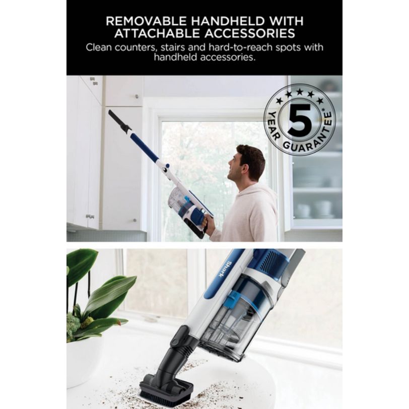 Shark PowerPro cordless stick vacuum in blue and white with removable handheld unit and attachable accessories, shown being used to clean high surfaces and floor debris, featuring 5 year guarantee badge