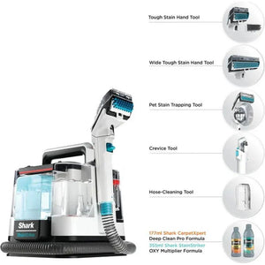 Shark StainStriker portable pet stain and spot cleaner with white and black body, transparent water tank, and six detachable cleaning tools displayed including tough stain hand tool, wide tough stain hand tool, pet stain trapping tool, crevice tool, hose-cleaning tool, and two bottles of cleaning formula