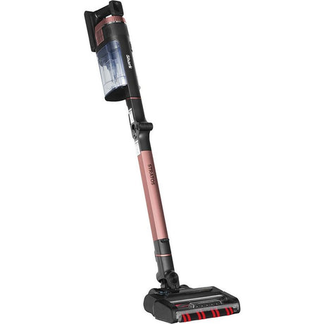 Shark Stratos Anti Hair Wrap cordless vacuum cleaner with rose pink telescopic pole, black motorhead with red accents, transparent dust canister, and black charging base on white background
