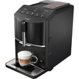 Siemens EQ300 black fully automatic bean to cup coffee machine with touch controls and display, dispensing cappuccino with milk froth into glass cup on drip tray