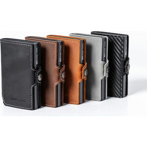 Five Wallet Junkie Pro Slim RFID-blocking wallets displayed in a row showing color options including midnight black, brown leather, tan, silver, and carbon fiber with white stitching and metal card ejector mechanism