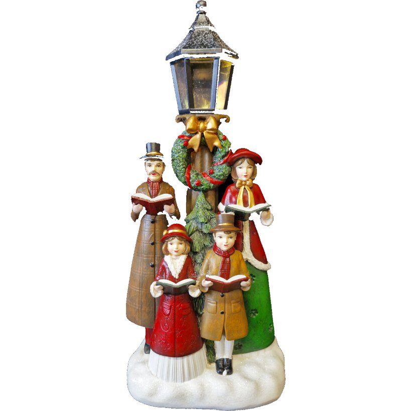 Decorative caroler figurine set featuring Victorian-style family of four figures in red, green and brown clothing holding songbooks, standing around a snow-covered base with illuminated brass lamp post topped with holly wreath and gold bow, Christmas holiday decoration