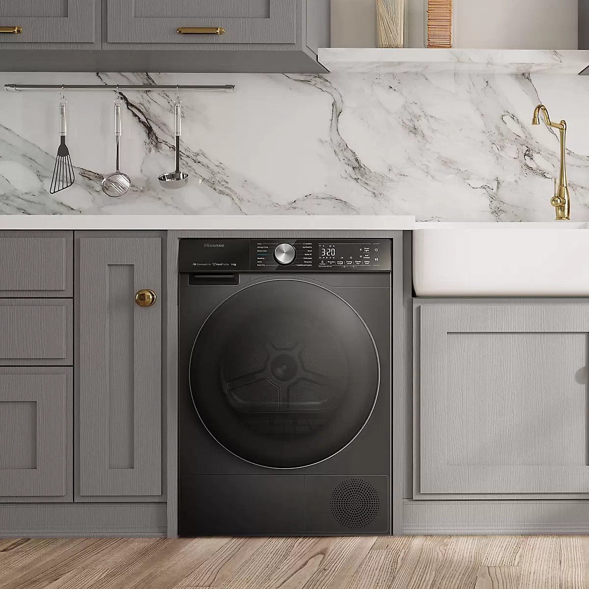 Modern kitchen with gray cabinets, marble countertop, and black appliance.