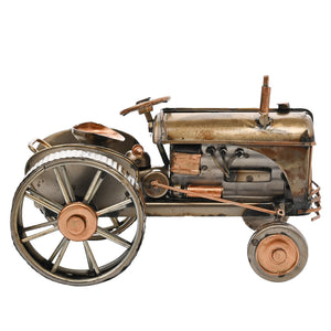 Vintage-style metal tractor ornament with copper and bronze details, featuring large spoked wheels, cylindrical boiler, smokestack, and steering wheel, crafted from aged iron and copper materials