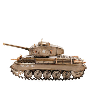 Detailed bronze metallic tank ornament model featuring rotating turret with star insignia, barrel gun, five road wheels with track treads, and military markings 604 AF 93 on side, isolated on white background