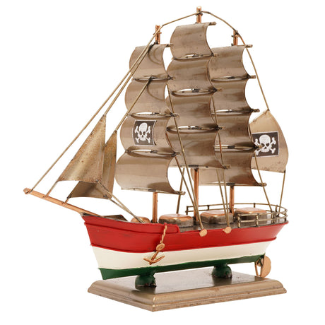 Model pirate ship with red hull, white deck, and brown sails on a white background