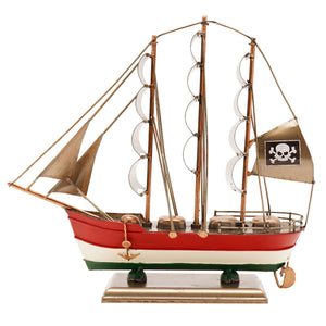 Decorative model pirate ship with red white and green striped hull, three wooden masts with tan sails, brass fittings, skull and crossbones flag, and circular porthole details, mounted on brass base
