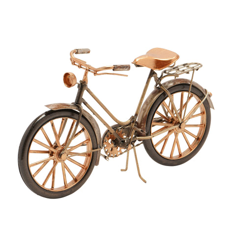 Model bicycle with bronze finish on a white background