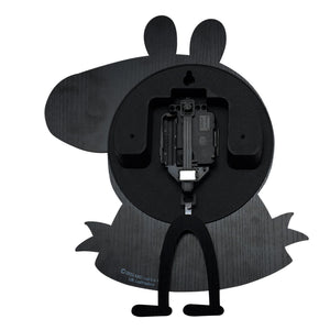 Rear view of black wooden Peppa Pig pendulum wall clock showing internal mechanism, battery compartment and swinging pendulum legs, copyright ABD Ltd and Hasbro