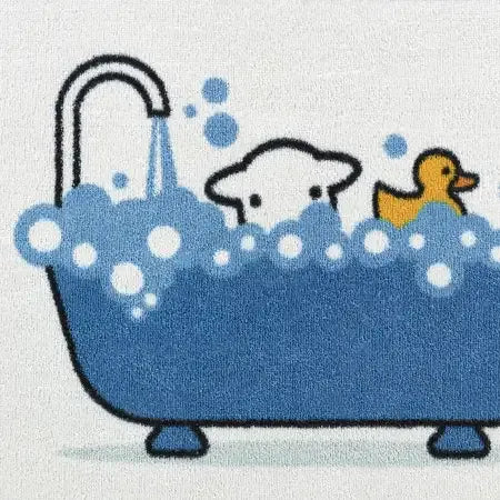 Hug Rug doormat featuring a cute bathtime illustration with a blue bathtub, white bubbles, a duck and sheep character in water, on a cream colored mat, 50cm x 75cm Bathtime Herdy design