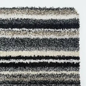 Hug Rug Candy Stripe doormat 50cm x 75cm featuring alternating horizontal stripes in black, white, grey and natural tones with textured loop pile surface