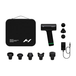 Hyperice Hypervolt 3 massage gun product set layout showing black carrying case, handheld percussion device with green accent stripe, power adapter, five interchangeable massage heads, and three attachment balls on white background