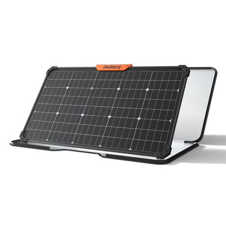 Jackery SolarSaga 80W portable solar panel with black frame and orange branding label, featuring dark solar cells with white connection points and white mesh backing panel, displayed at an angled position