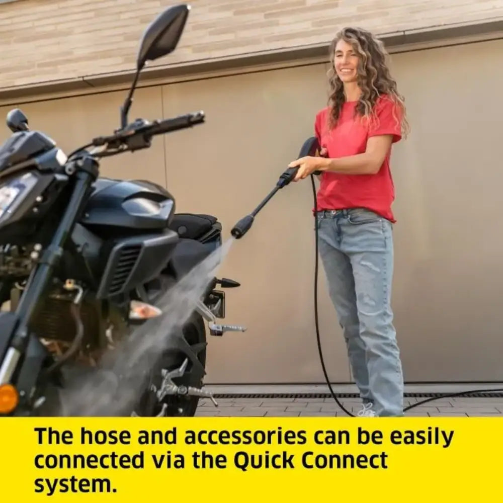 Woman washing a motorcycle with a pressure washer, text about quick connect system.