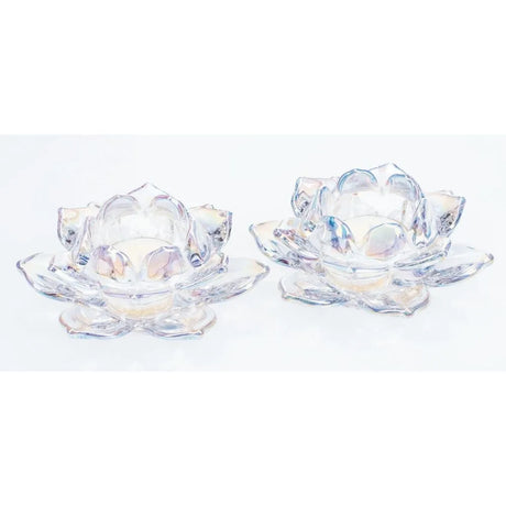 Pair of clear glass lotus-shaped tealight holders with iridescent lustre finish, featuring petal-like segments and central circular wells, displayed against a white background