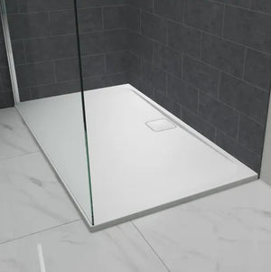 Merlyn Level25 white rectangular shower tray with 25mm height installed in modern bathroom with dark grey tile walls and marble effect flooring, featuring glass shower screen panel