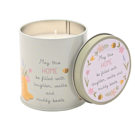 Decorative candle in a tin with a motivational quote on a white background