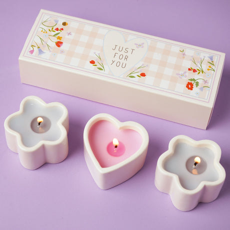 Flower-shaped candles with a 'Just For You' box on a purple background