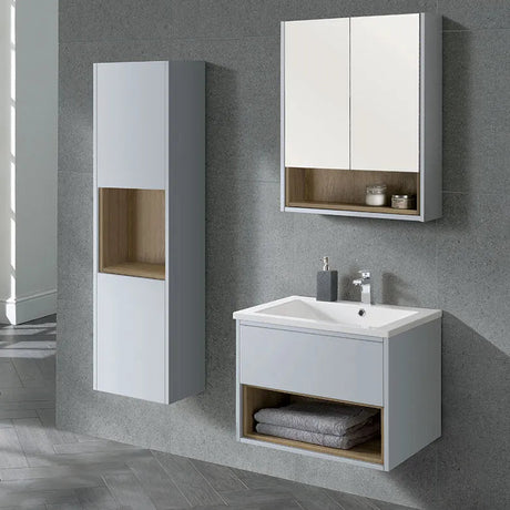 Modern white wall-mounted bathroom vanity unit with integrated sink and wooden accent shelf, paired with matching white mirrored medicine cabinet and tall storage tower on grey tiled wall