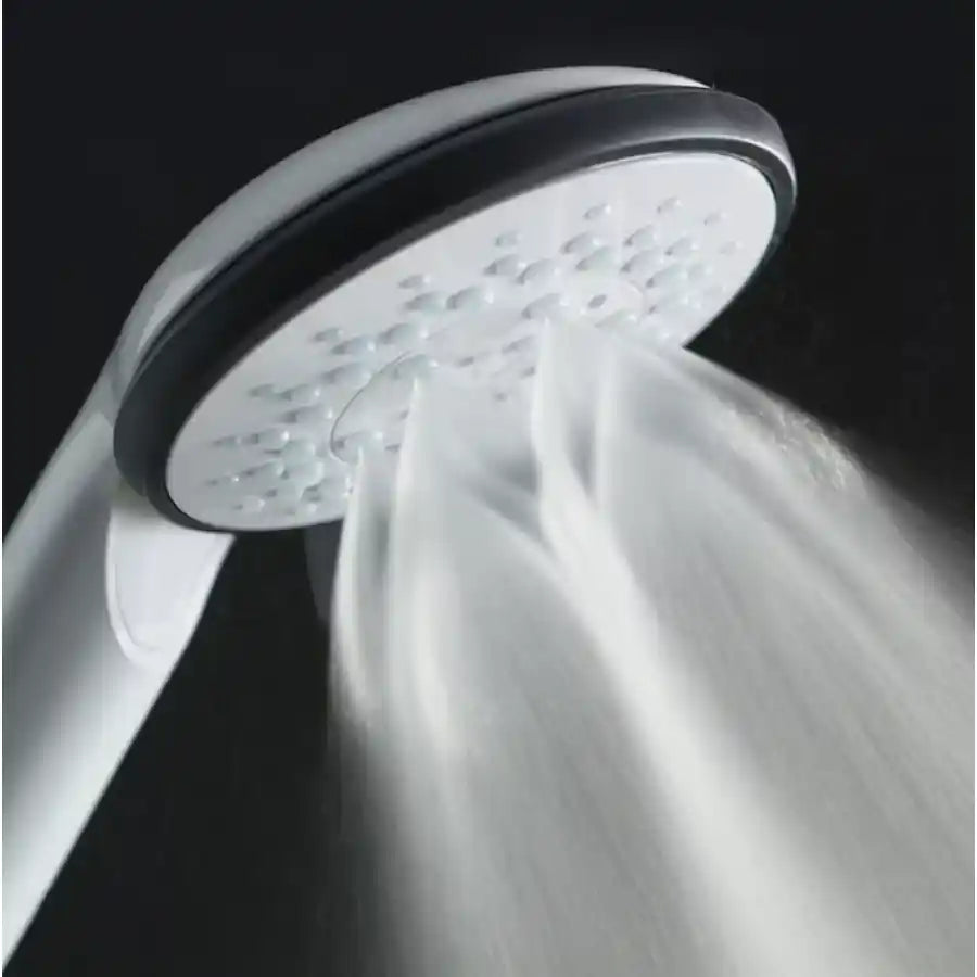 Shower head with water flowing against a dark background