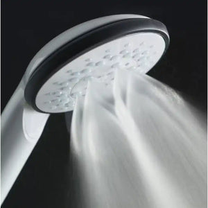 Shower head with water flowing against a dark background