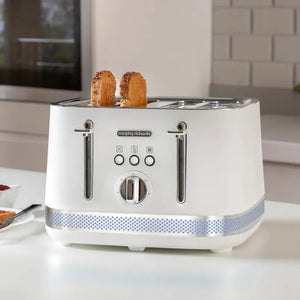 White Morphy Richards Illumination 4 slice toaster with two slices of toasted bread popping up, featuring chrome handles, control dials, and a blue patterned accent band around the base, displayed on a white kitchen counter