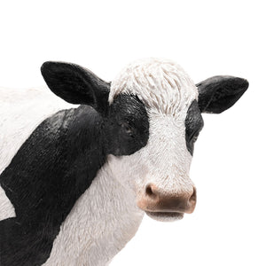 Black and white painted standing cow figurine, 34cm Naturecraft model NC1330, realistic farm animal sculpture with detailed features on white background