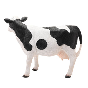 Naturecraft Standing Cow 34cm figurine with black and white coloring, realistic detailing, pink udder, and black hooves on white background